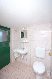 a bathroom with a toilet and a sink at House Krunoslav in Postira