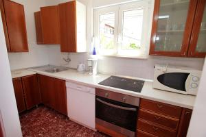a kitchen with a sink and a microwave at Apartment Baturina in Trogir