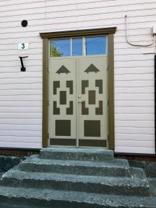 a door on a house with stairs in front of it at Chelsea Karusselli 3 Apartment in Pärnu