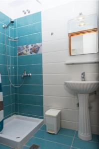 a bathroom with a sink and a shower and a toilet at Studio Stars in Laganas