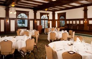 a banquet hall with white tables and chairs at The Stanley Hotel in Estes Park +30 photos
