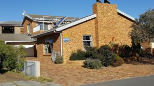 una casa in mattoni con un vialetto di mattoni davanti di Breakaway Apartment with Balcony a Yzerfontein