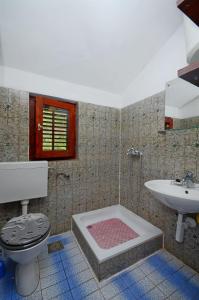 a bathroom with a toilet and a sink at Apartments Antun in Vrboska
