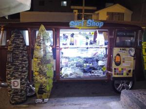 a surf shop with two surfboards in front of it at My Friend Surf Hostal in Trujillo