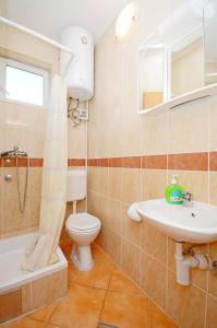 a bathroom with a toilet and a sink at Apartments Josko in Gradac +53 photos