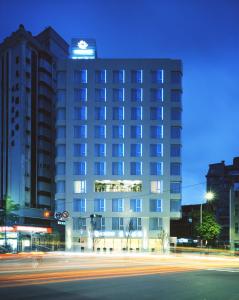 a tall building with a street in front of it at Ambience Hotel Taipei in Taipei