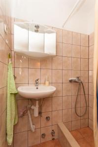 a bathroom with a sink and a shower at House Vela Lozna in Postira