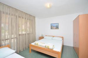 a bedroom with a bed and a large window at Apartment Gordan in Murter +40 photos