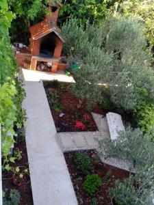 un jardín con una casa de aves y algunas plantas en Apartments Mira, en Velike Kuknjare