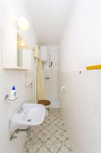 a bathroom with a sink and a toilet at House Rose in Živogošće