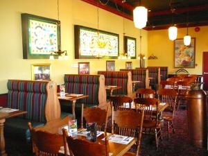 a dining room with tables and chairs and tables and chairs at Coast Abbotsford Hotel & Suites in Abbotsford