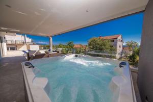a large hot tub on the patio of a house at Relax Derossi in Crikvenica