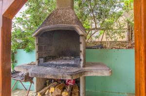 an outdoor oven with a bunch of fire inside at Apartments Nevenka in Sumpetar