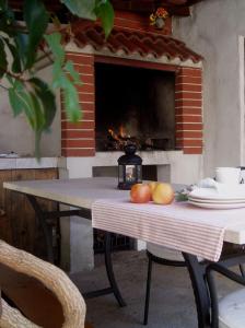 a table with fruit on it with a fireplace at Apartments Mirjana in Rukavac