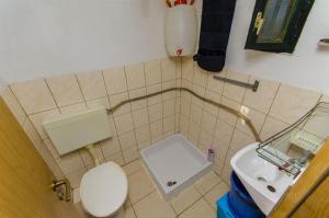 a small bathroom with a toilet and a sink at House Fisherman in Postira