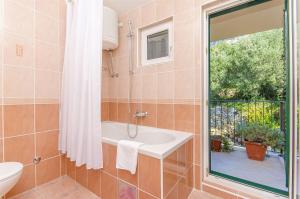 a bathroom with a sink and a window at Apartments Kunac in Podgora