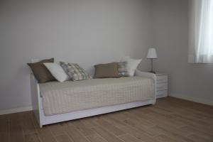 A bed or beds in a room at Appartamenti Emilio