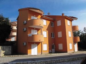 a large orange building on the side of a street at Apartment Ivan in Šilo