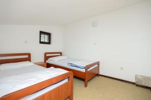 Postel nebo postele na pokoji v ubytování Apartments Dragica