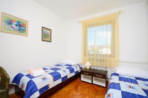 Postel nebo postele na pokoji v ubytování Apartments Dragica