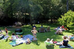 a group of people sitting on the grass in a park at Big Sur River Inn in Big Sur