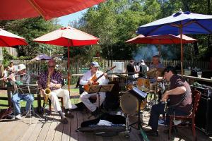 a group of people playing music under umbrellas at Big Sur River Inn in Big Sur