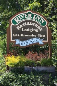 a sign for the river inn residential loading gas groceries cities at Big Sur River Inn in Big Sur