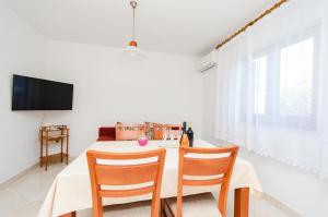 a dining room with a table and two chairs at Apartment Marija in Poreč