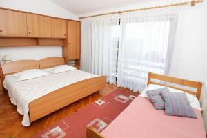 Łóżko lub łóżka w pokoju w obiekcie Apartments Patricia