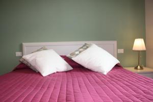 A bed or beds in a room at Appartamenti Emilio