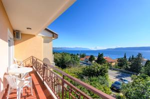 a balcony with a table and chairs and a view of the water at Apartment Marija in Novi Vinodolski