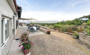 a patio with a table and chairs and flowers at Apartment Sanja in Martina +25 photos