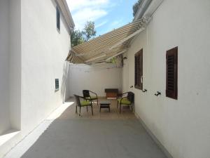 a patio with chairs and a table in a building at Apartment Ivana in Biograd na Moru