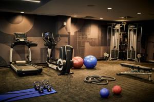 a gym with exercise equipment and balls on the floor at Detroit Foundation Hotel in Detroit
