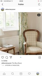 a room with a chair and a table and a window at The Old Rectory in Campsea Ashe