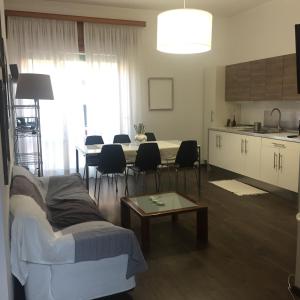 a living room with a couch and a table and a kitchen at Calabria Mare Ionio - La Casa di Anna - Siderno Marina in Siderno Marina