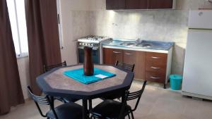 a small kitchen with a table with a vase on it at Kaizen in Mendoza