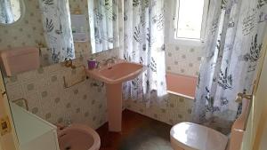 a bathroom with a sink and a toilet and a window at Casa Bellavista in Segovia +29 photos