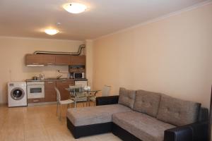 a living room with a couch and a kitchen at Apartment in Luxury Resort Sveti Vlas in Sveti Vlas