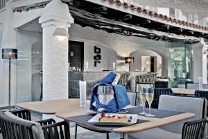 a dining room with a table with a bag on it at Hotel Boutique Ses Pitreras in San Antonio Bay