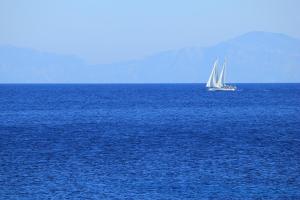 a sail boat in the middle of the ocean at Mando Beachfront in Stafylos