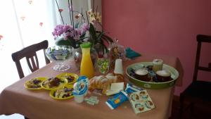 a table with a table cloth with food on it at B&B Il Giardino Diamante in Diamante