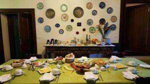 a table with plates on the wall in a room at Solar do Morgado Oliveira in Macedo de Cavaleiros