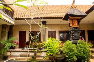 a house with a lot of plants in front of it at Umah Bukit House in Uluwatu