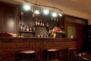 a bar with some stools in a restaurant at Akrolimnia in Kalyvia