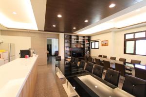 an empty waiting room with chairs and a counter at Long Xing B&B in Huxi +20 photos