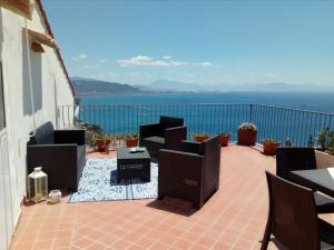 a patio with chairs and a view of the ocean at L'Azzurro e il Blu' in Vietri sul Mare