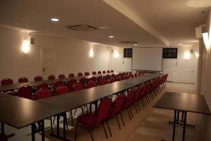 a conference room with a long table and red chairs at Willa Agnieszka in Kazimierz Dolny