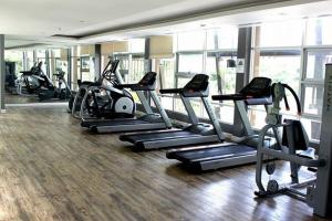 a gym with a bunch of tread machines in a room at Condo BaanTiewLom by Sipa in Cha Am