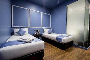 Postel nebo postele na pokoji v ubytování Bloommaze Boutique Hotel Puchong + 37 fotografií
